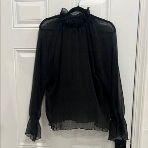 Never worn black long sleeve blouse. Size is undetermined fits like a XL.